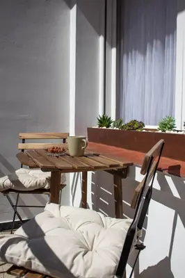 a wooden table and a chair with a bowl on it at a casa da Alicia in Monforte de Lemos