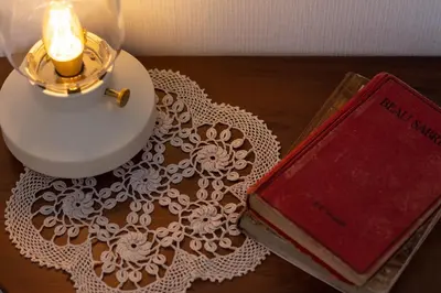 a table with a candle and a book on a table at a casa da Alicia in Monforte de Lemos