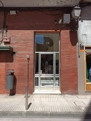 a store front with a glass door on a brick building at a casa da Alicia in Monforte de Lemos