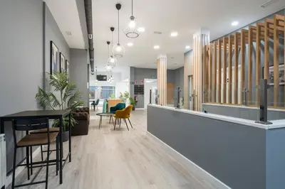 an office lobby with a table and chairs at Albergue Alda Pilgrim Ponferrada in Ponferrada