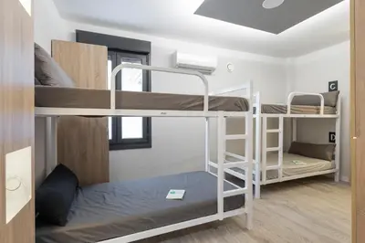 a room with three bunk beds in it at Albergue Alda Pilgrim Ponferrada in Ponferrada