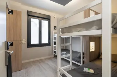 a room with bunk beds and a window at Albergue Alda Pilgrim Ponferrada in Ponferrada