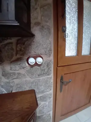 a door with two detectors on a stone wall at Stone Cottage La COMPOSTELANA in Curtis