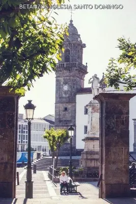 a building with a clock tower in a city at Stone Cottage La COMPOSTELANA in Curtis