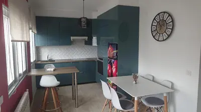 a small kitchen with a table and a table and chairs at Foz Playas in Foz