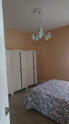 a bedroom with a bed and a chandelier at Foz Playas in Foz