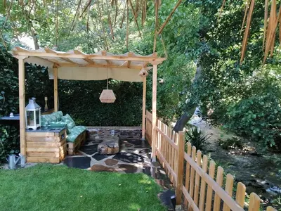 a garden with a gazebo and a water feature at A curuxa casa rural in El Mazo