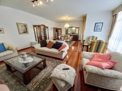 a living room with couches and a coffee table at Ático Pilos in Castro Caldelas
