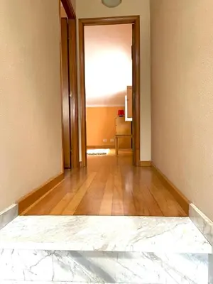 an empty room with a wooden floor and a hallway at Casa Concha do Caserón do Viaxeiro in Mondoñedo