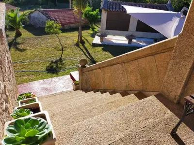 a set of stairs leading up to a house with a garden at LA CAMELIA in Pontevedra