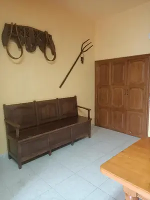 a room with a couch and a gun on the wall at LA CAMELIA in Pontevedra