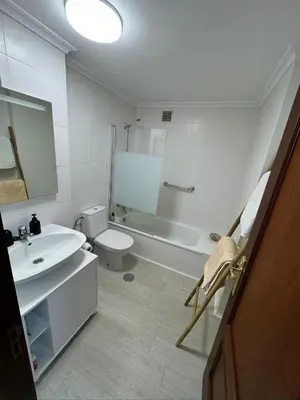 a white bathroom with a sink and a toilet at Apartamento a 5 minutos del casco histórico in Viveiro