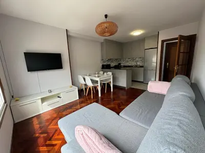 a living room with a couch and a table at Apartamento a 5 minutos del casco histórico in Viveiro