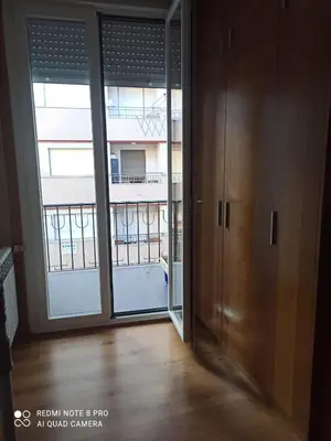 an empty room with sliding glass doors and a balcony at Aroalia, super céntrico!! in Ourense