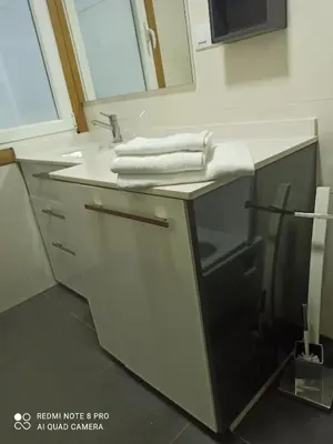 a bathroom with a sink with towels on it at Aroalia, super céntrico!! in Ourense