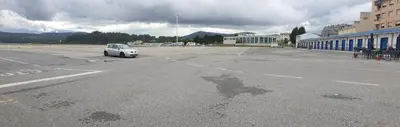 a white car parked in an empty parking lot at Piso puerto Foz in Foz