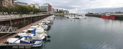 a group of boats docked in a harbor at Piso puerto Foz in Foz