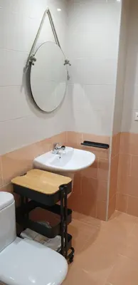 a bathroom with a sink and a mirror and a toilet at Piso puerto Foz in Foz