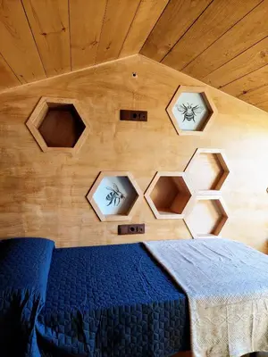 a bed in a room with a wooden ceiling at Fogar de Breogán in Pontevedra