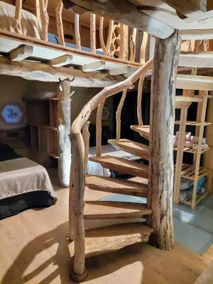 a wooden spiral staircase in a log cabin at Fogar de Breogán in Pontevedra