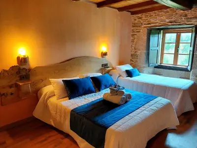 a bedroom with two beds in a room at Fogar de Breogán in Pontevedra
