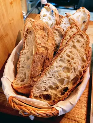 a basket filled with slices of bread on a table at Fogar de Breogán in Pontevedra