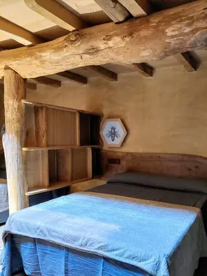 a bedroom with a bed in a log cabin at Fogar de Breogán in Pontevedra