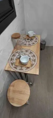 two wooden tables with plates and bowls on them at Precioso Apartamento de 1 Habitación in O Barco de Valdeorras