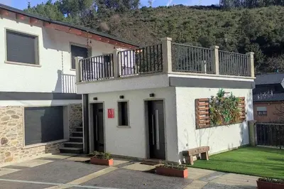 a white house with a balcony on top of it at Precioso Apartamento de 1 Habitación in O Barco de Valdeorras