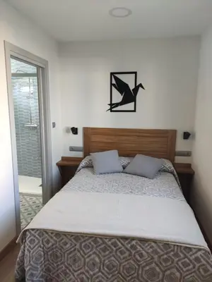 a bedroom with a bed with two pillows on it at A Casiña do Camiño in Baamonde