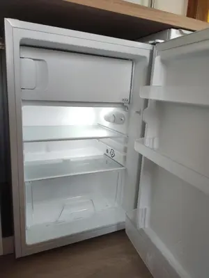 an empty refrigerator with its door open in a kitchen at A Casiña do Camiño in Baamonde