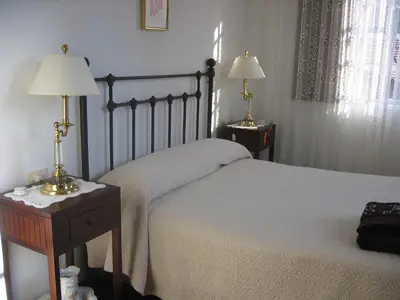 a bedroom with a bed and two lamps on tables at Casa de Alicia Pontevedra Moraña Rías Baixas Casa Entera VT-PO-OOOO32 in Moraña