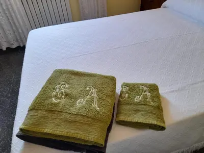two towels on a bed with handwriting on them at Casa de Alicia Pontevedra Moraña Rías Baixas Casa Entera VT-PO-OOOO32 in Moraña