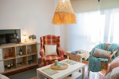 a living room with two chairs and a table at Luxury Singular Apartments Green in Santiago de Compostela