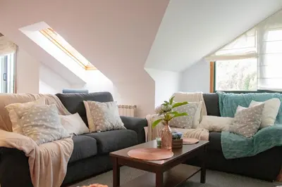 a living room with two couches and a table at Luxury Singular Apartments Green in Santiago de Compostela