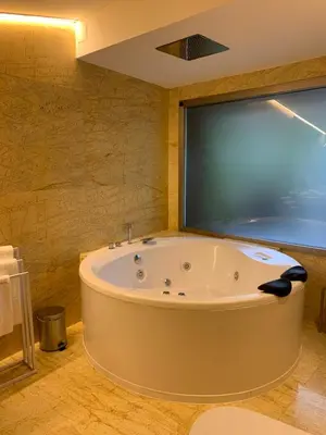 a large tub in a bathroom with a large window at ESPEJO DE SOLEDADES in Vigo de Sanabria