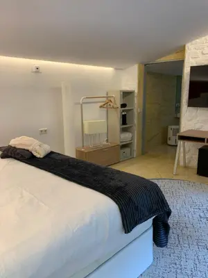 a bedroom with a large white bed in a room at ESPEJO DE SOLEDADES in Vigo de Sanabria
