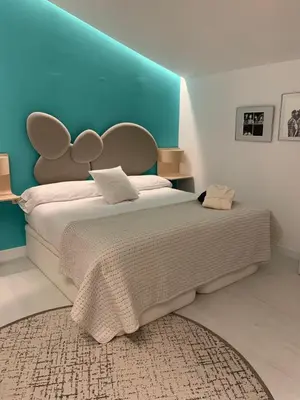 a bedroom with a large bed with a blue headboard at ESPEJO DE SOLEDADES in Vigo de Sanabria