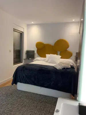 a bedroom with a large bed with a large headboard at ESPEJO DE SOLEDADES in Vigo de Sanabria