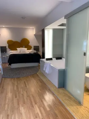 a bedroom with a bed and a large mirror at ESPEJO DE SOLEDADES in Vigo de Sanabria