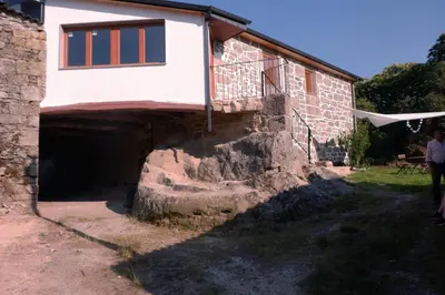 an entrance to a brick house with a stone wall at A casa da Penela in Sas de Penelas