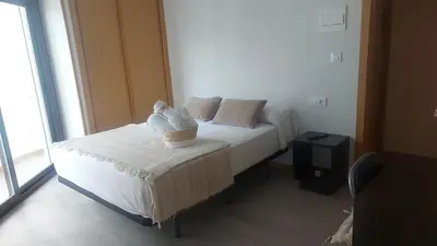 a bedroom with a bed with a basket on it at New J&J Hostel in Ourense