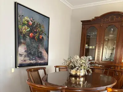 a dining room with a table with a vase of flowers at Casa Santa Ana in Tourón