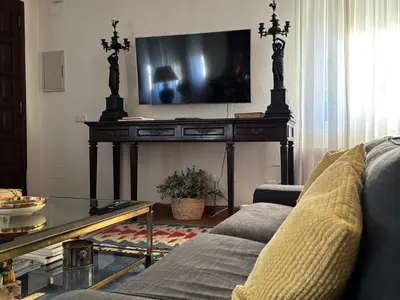 a living room with a couch and a tv on a table at Casa Santa Ana in Tourón