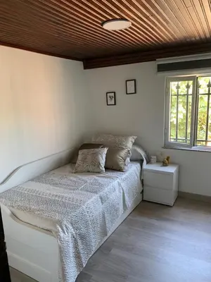 a bedroom with a bed with a wooden ceiling at Casa ferreiro in Ribadeo