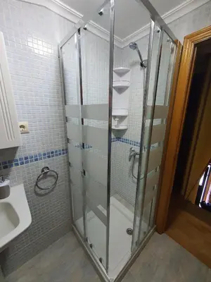 a shower with a glass door in a bathroom at A Palleira de Aguil in Castro Caldelas