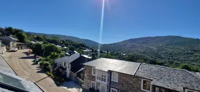 an aerial view of a town with mountains in the background at Casa jardin Mariana in Lubián