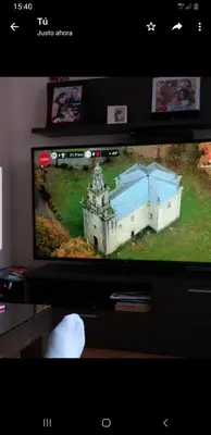 a television screen with a picture of a castle on it at Casa jardin Mariana in Lubián