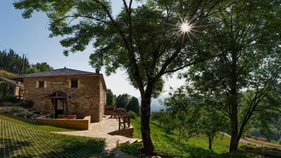 a stone building with a tree in front of it at Casa Liñeiras in Lugo
