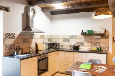 a kitchen with a table and a stove top oven at Casa Liñeiras in Lugo